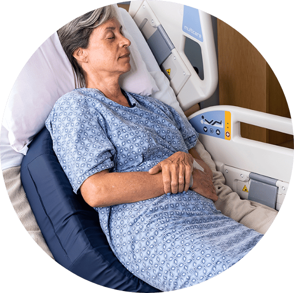 patient in bed using a Bedsore Rescue wedge cushion